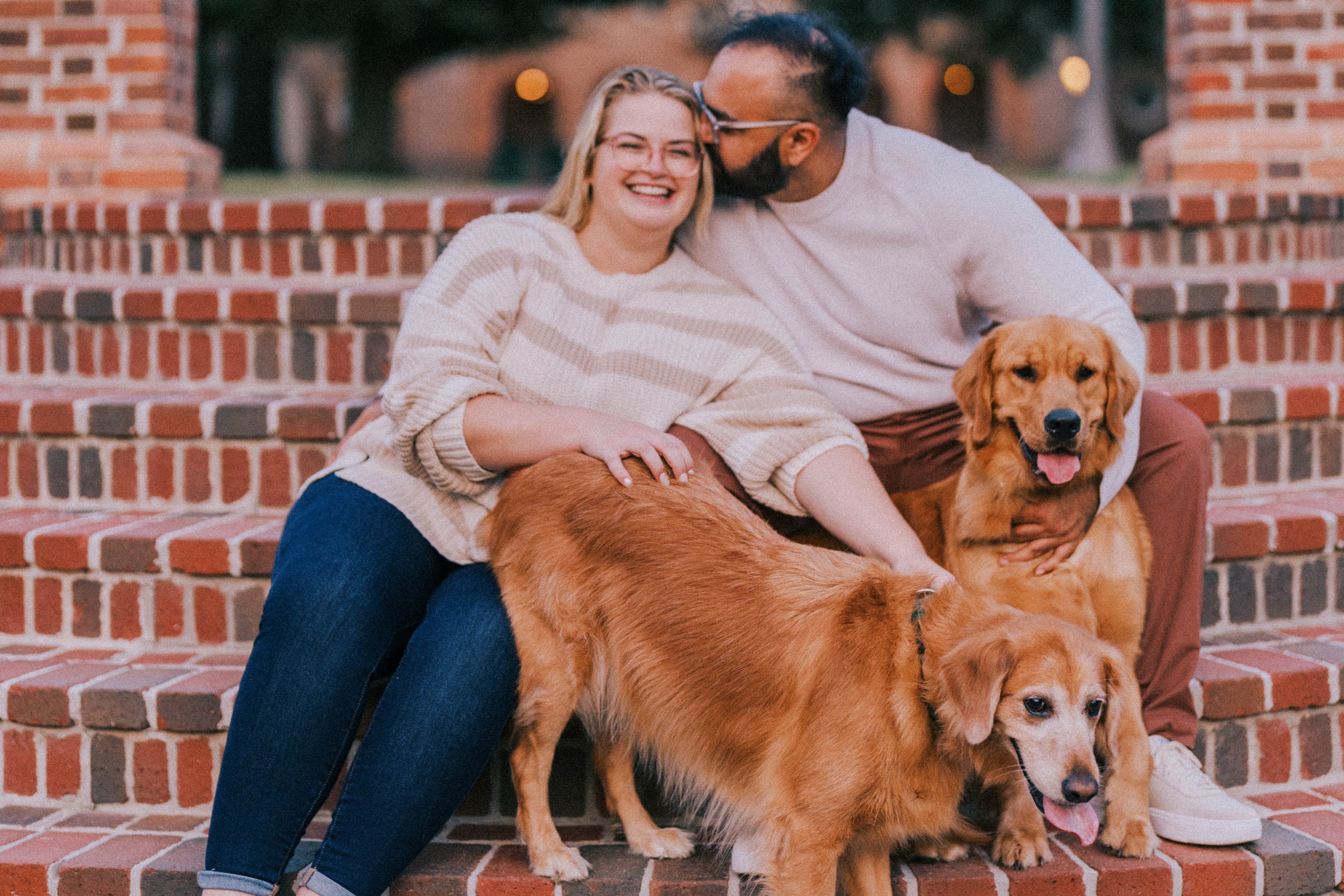 Pastor Kelsey with her husband, Rahum, and their two dogs on the Steps of the Sunken Gardens at William and Mary